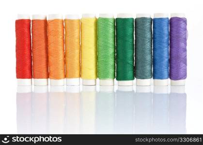 rainbow color spools threads isolated on white