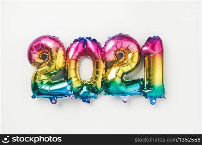 Rainbow colored Foil balloons in the form of numbers 2021. New year celebration. Holiday party decoration, flat lay