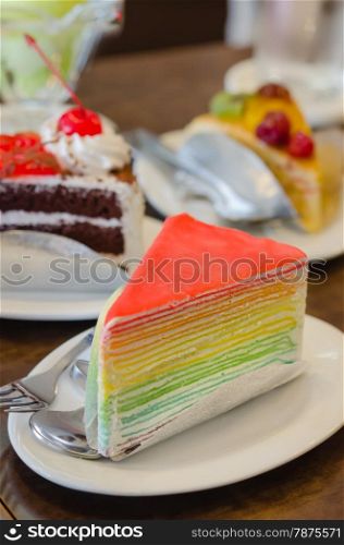 Rainbow crepe cake served , dessert on dish