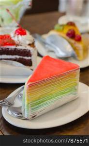 Rainbow crepe cake served , dessert on dish