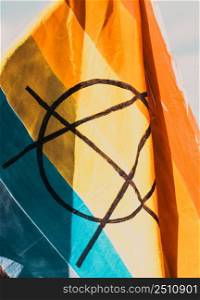 rainbow flag with peace symbol at pride parade