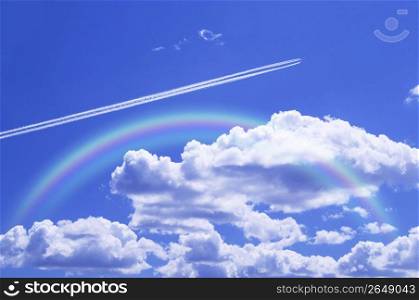 Rainbow in a bright blue cloudy sky