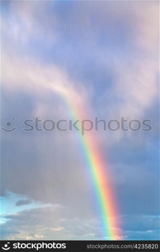 rainbow in autumn blue cloudy afternoon sky