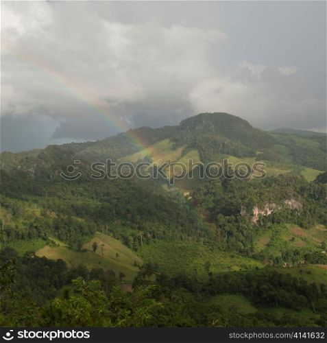 Rainbow over a field, Thailand