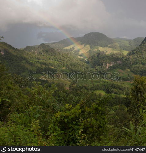 Rainbow over a field, Thailand