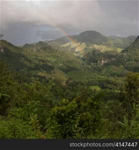 Rainbow over a field, Thailand