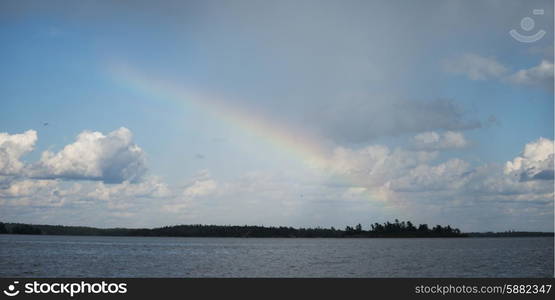 Rainbow over a lake, Lake of the Woods, Ontario, Canada