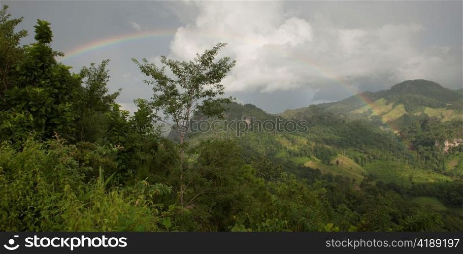 Rainbow over a mountain range, Thailand