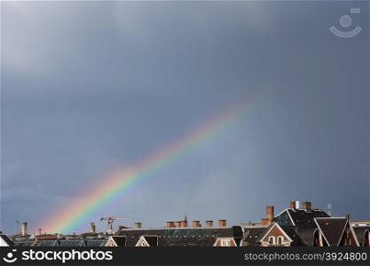 Rainbow over roofs. Rainbow over the roofs of Copenhagen in Denmark
