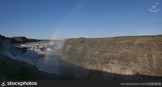 Rainbow over waterfall