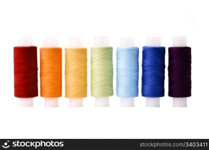 Rainbow threads. Multicoloured threads spools arranged in line as rainbow