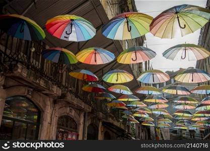 rainbow Umbrellas at the Party Street of Nova do Carvalho in Baixa in the City of Lisbon in Portugal. Portugal, Lisbon, October, 2021