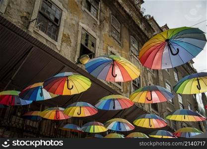 rainbow Umbrellas at the Party Street of Nova do Carvalho in Baixa in the City of Lisbon in Portugal. Portugal, Lisbon, October, 2021