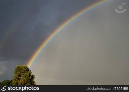 rainbow with dark clouds and bad weather
