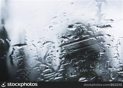 Raindrops on glass during the rainy season.