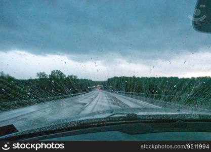 Raindrops on the windshield The view from the inside of the car, driving in the rain