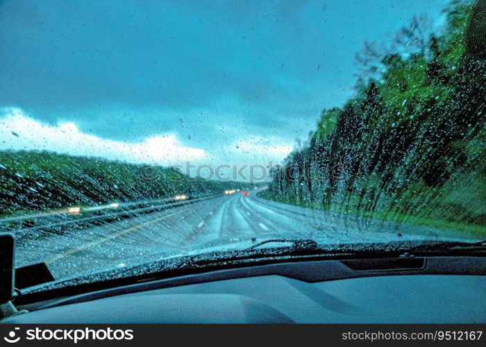 Raindrops on the windshield The view from the inside of the car, driving in the rain