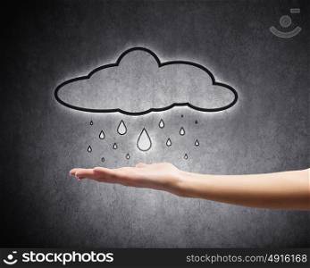Raining weather. Background conceptual image with raining cloud in hand