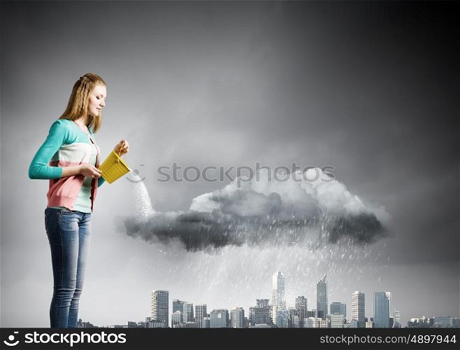 Raining weather. Young woman in casual pouring water on city