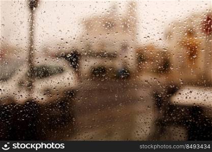 Rainy city background. Raindrops on window glass on autumn day. Wet home window with raindrops. High quality photo.. Rainy city background. Raindrops on window glass on autumn day. Wet home window with raindrops. High quality photo
