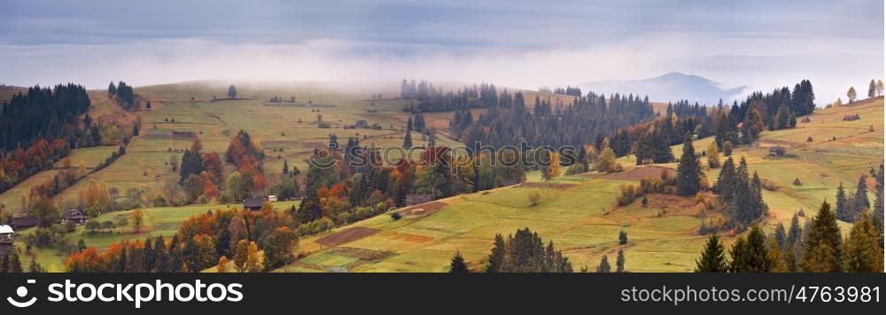 Rainy landscape of mountain village. Overcast autumn panorama. Bad weather.