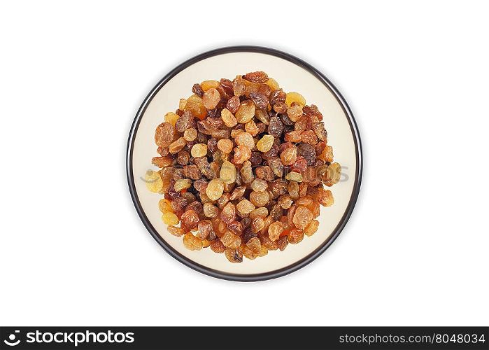 Raisins in a clear glass dish top view close up isolated