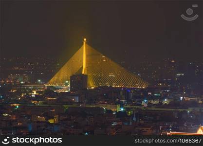 Rama 8 Bridge and Chao Phraya River in structure of suspension architecture concept, Urban city, Bangkok. Downtown area at night, Thailand.