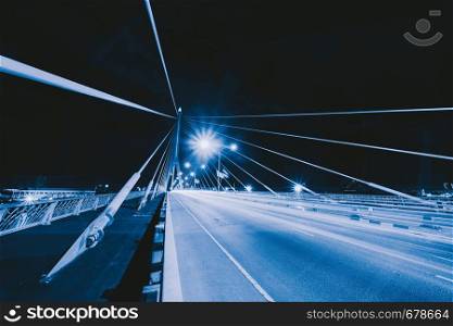 Rama 8 Bridge with road or street and cables in structure of suspension architecture concept, Urban city, Bangkok. Downtown area at night, Thailand.