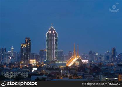 Rama 9 bridge and Kasikorn Building, with skyscraper high rise buildings in urban city, Downtown Bangkok skyline, Thailand at night.