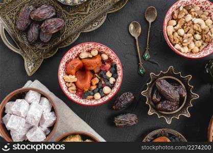 ramadan juicy dates dried fruits nuts lukum black background. Resolution and high quality beautiful photo. ramadan juicy dates dried fruits nuts lukum black background. High quality beautiful photo concept