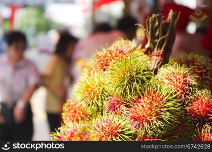 rambutan fruits on sale in asia street, exotic tropical fruit.