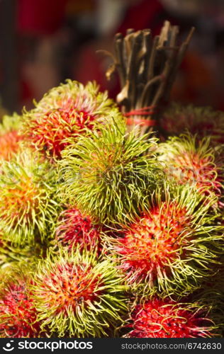 rambutan fruits on sale in asia street, exotic tropical fruit.