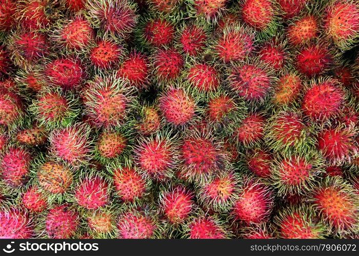 Rambuthan fruits at the market in the city of Amnat Charoen in the Region of Isan in Northeast Thailand in Thailand.&#xA;