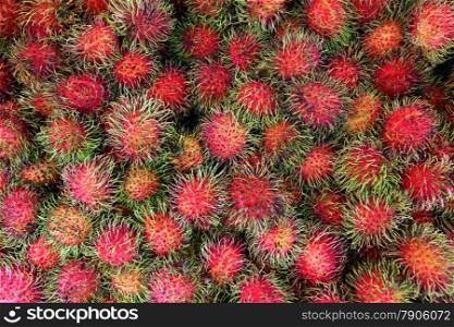 Rambuthan fruits at the market in the city of Amnat Charoen in the Region of Isan in Northeast Thailand in Thailand.&#xA;