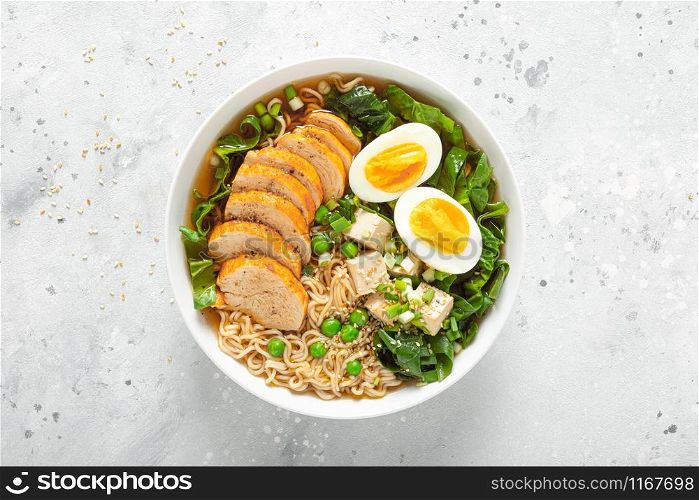 Ramen noodle soup with chicken breast, egg and spinach