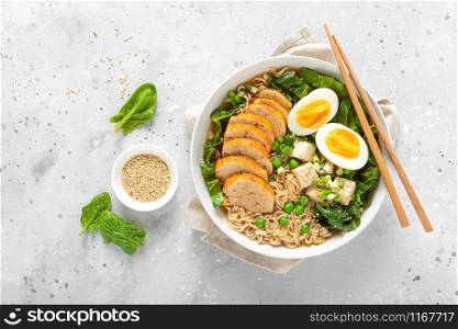 Ramen noodle soup with chicken breast, egg and spinach