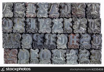 random alphabet letters in decorative metal letterpress type - initials font - stained by color inks