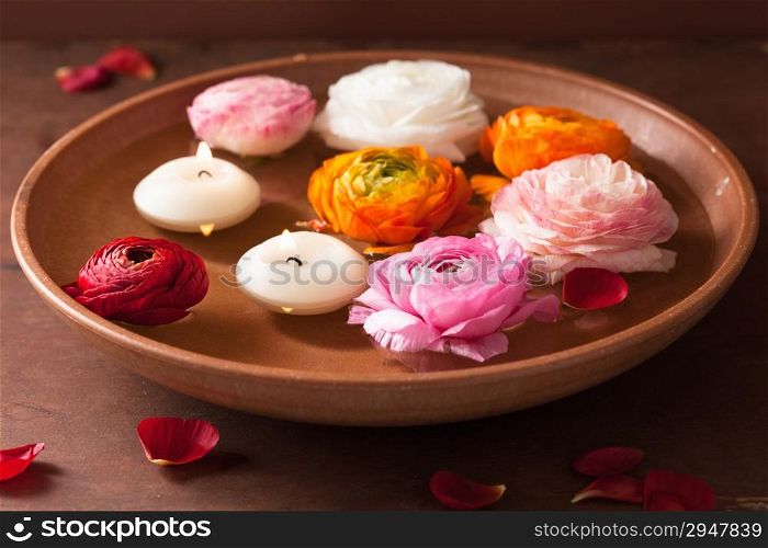 ranunculus flowers and canclles in bowl for spa