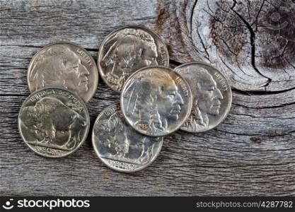 Rare buffalo head nickel coins on rustic wood