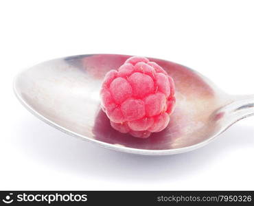 raspberries and spoon on a white background