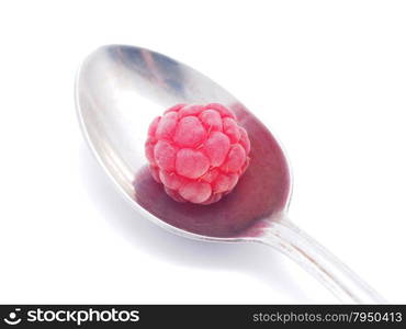 raspberries and spoon on a white background