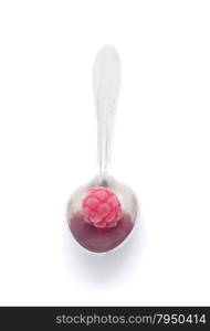 raspberries and spoon on a white background