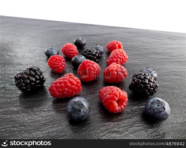 Raspberries, blackberries and blueberries on a slate plate &#xA;