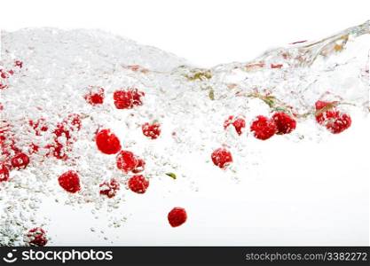 Raspberries floating in water with bubbles and waves