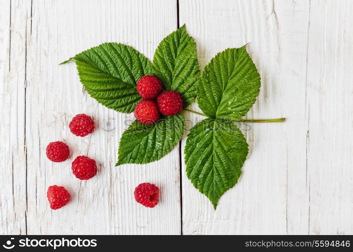 Raspberries on a wooden white table