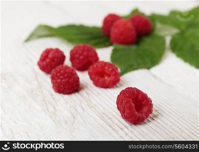 Raspberries on a wooden white table