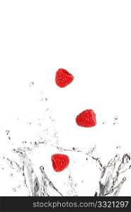 Raspberries splashing in water