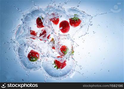 Raspberries splashing into clear water, view from top. Health food concept. Raspberries splashing into clear water, view from top