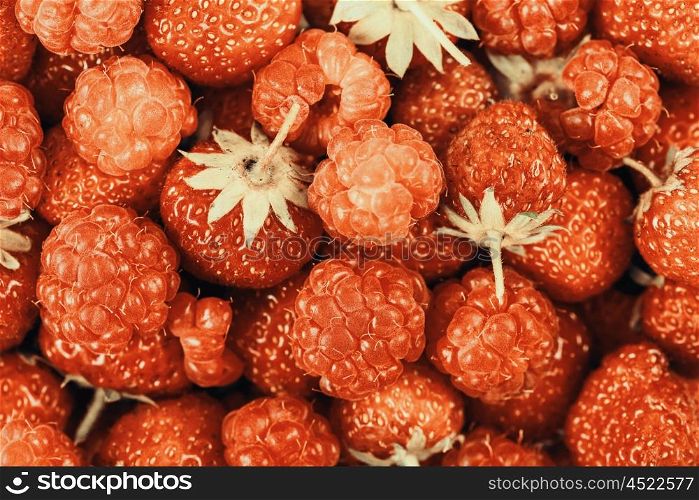 Raspberry And Strawberry Pile In Fruit Market