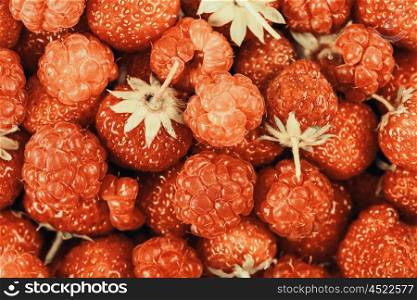 Raspberry And Strawberry Pile In Fruit Market